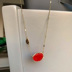 Gold necklace with red pendant